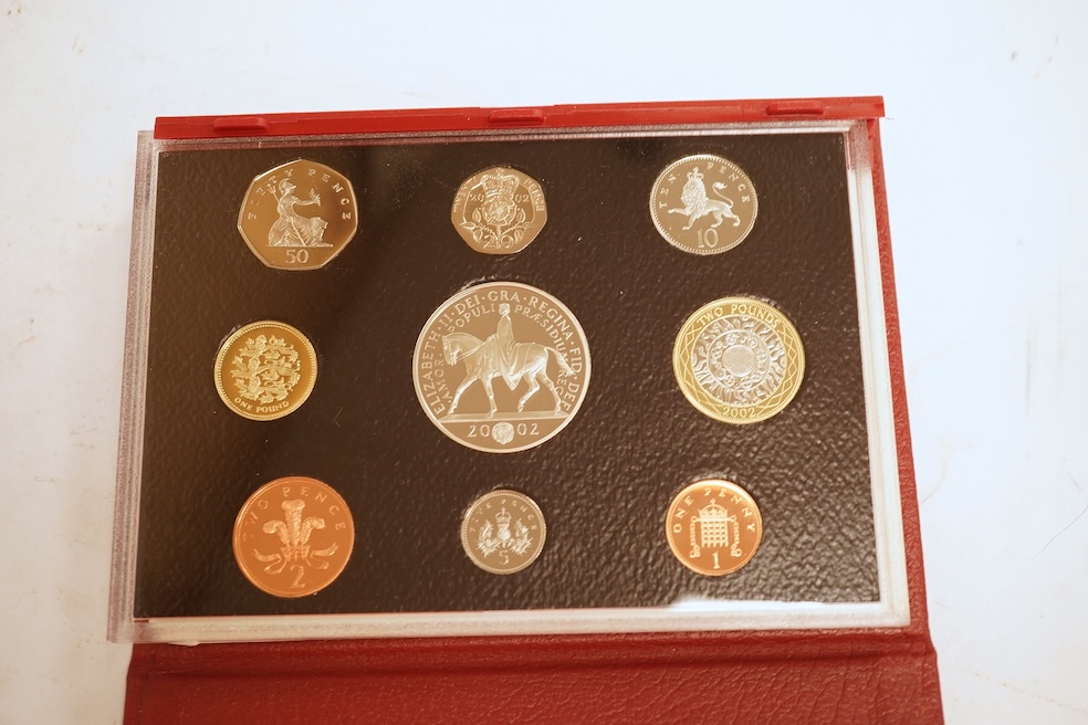 A collection of cased silver and cupro nickel proof and uncirculated sets and coins, including four Royal Mint UK proof coin year sets for 2002-2005, Royal Mint UK silver proof £2, London mint office silver commemorative